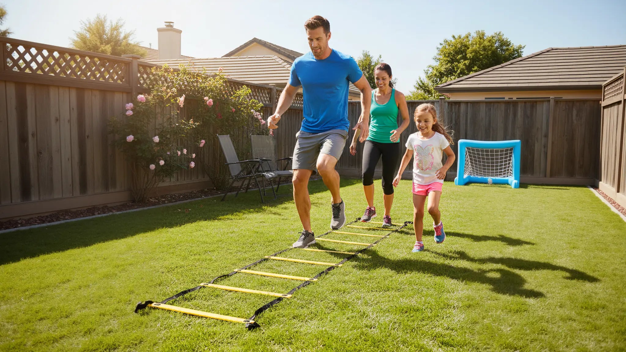 A smiling family—father, mother, and daughter—run through a yellow agility ladder doing fitness drills in their sunny backyard.