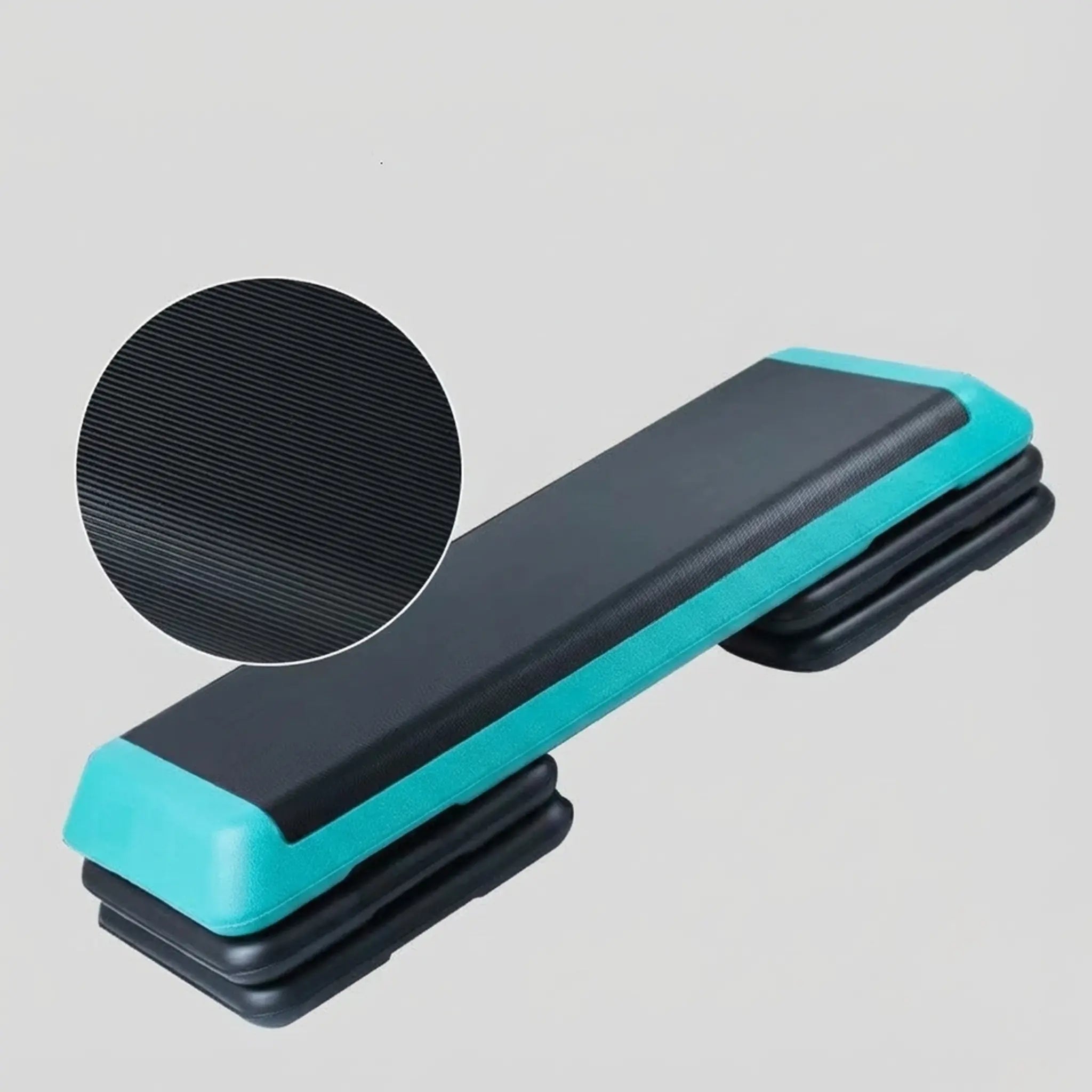 Step platform with black textured surface and teal sides on a gray background