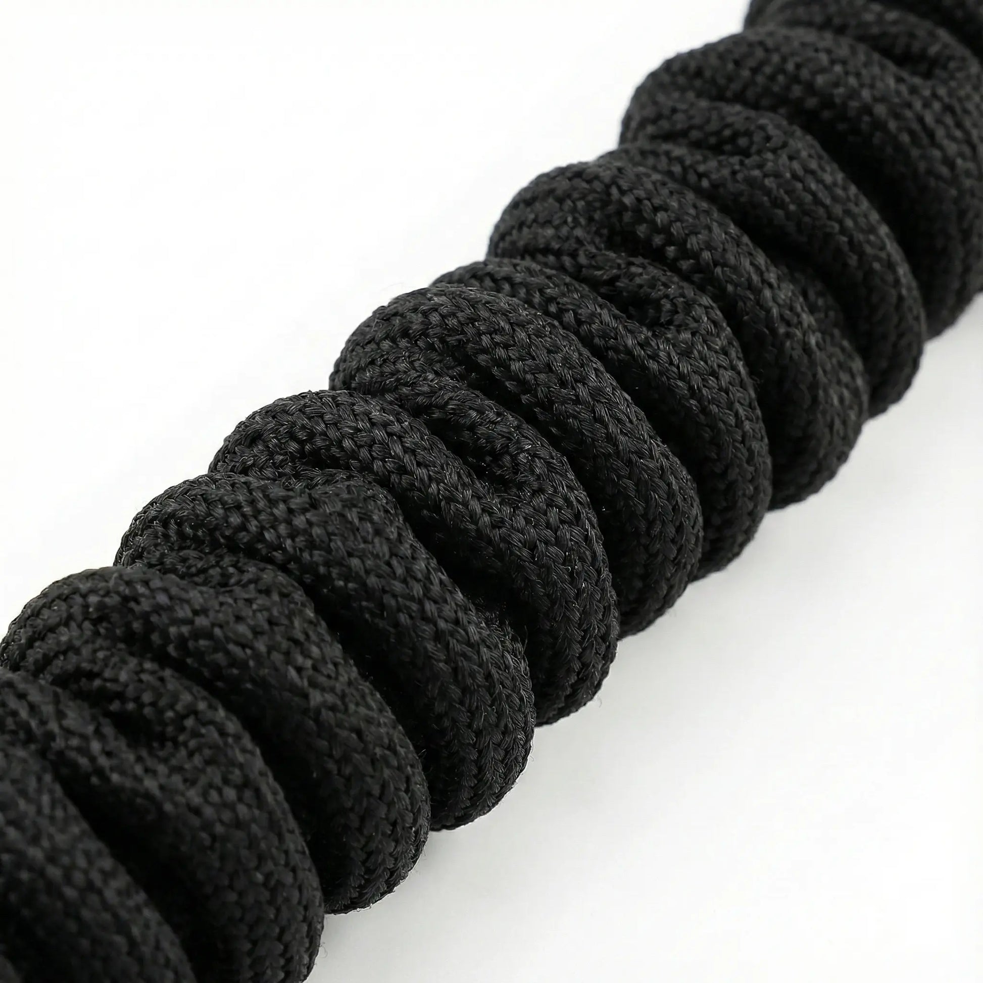 Close-up view of the durable woven black nylon safety sleeve on our resistance band, designed for anti-snap protection.
