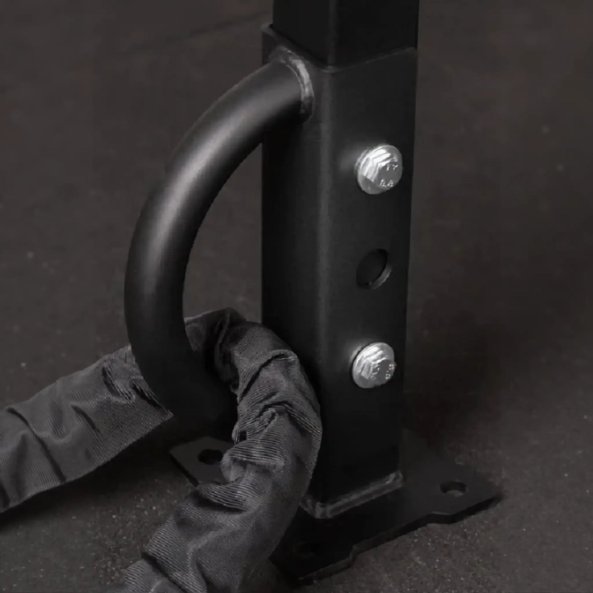 Battle rope anchor mounted to power rack with rope attached.