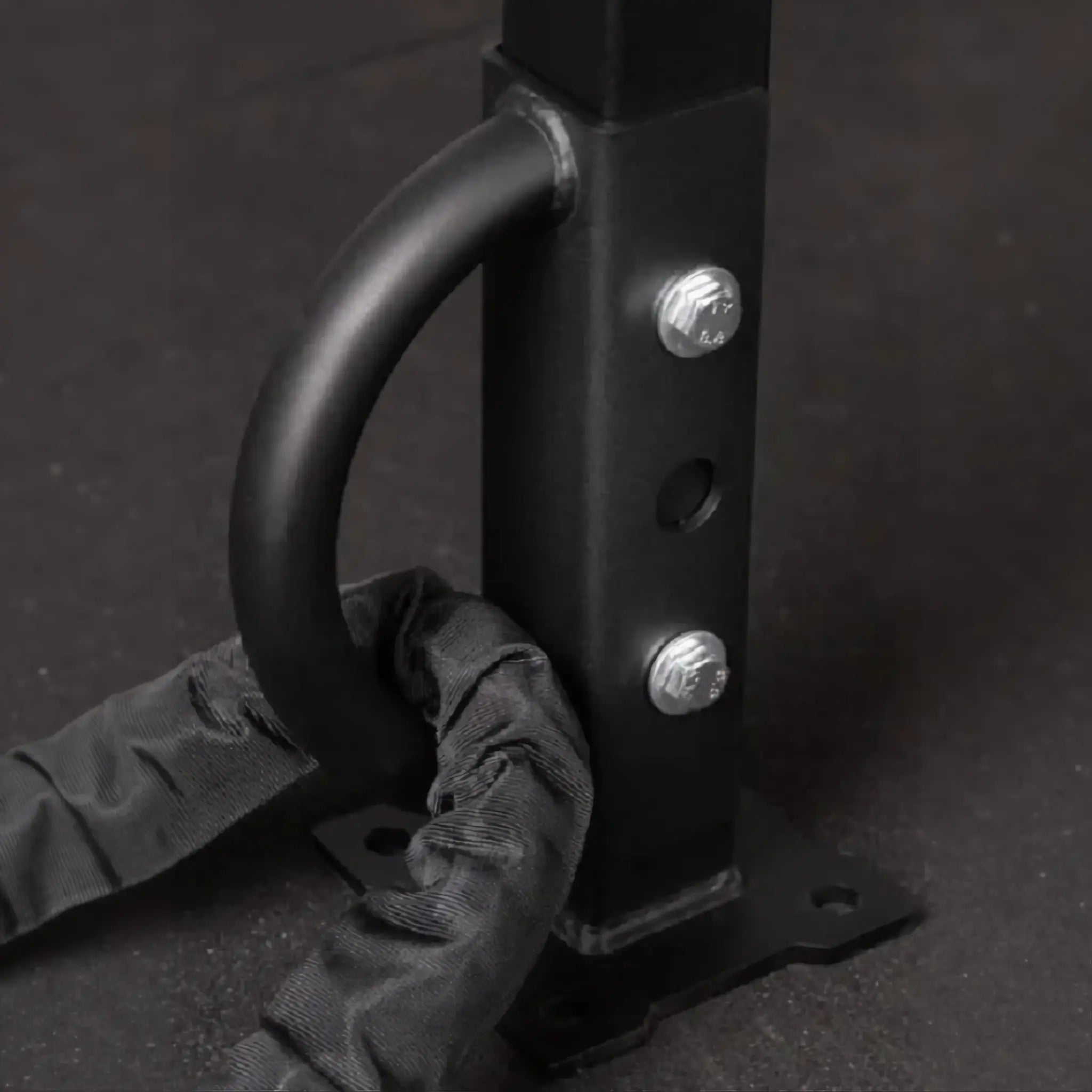 Battle rope anchor mounted to power rack with rope attached.
