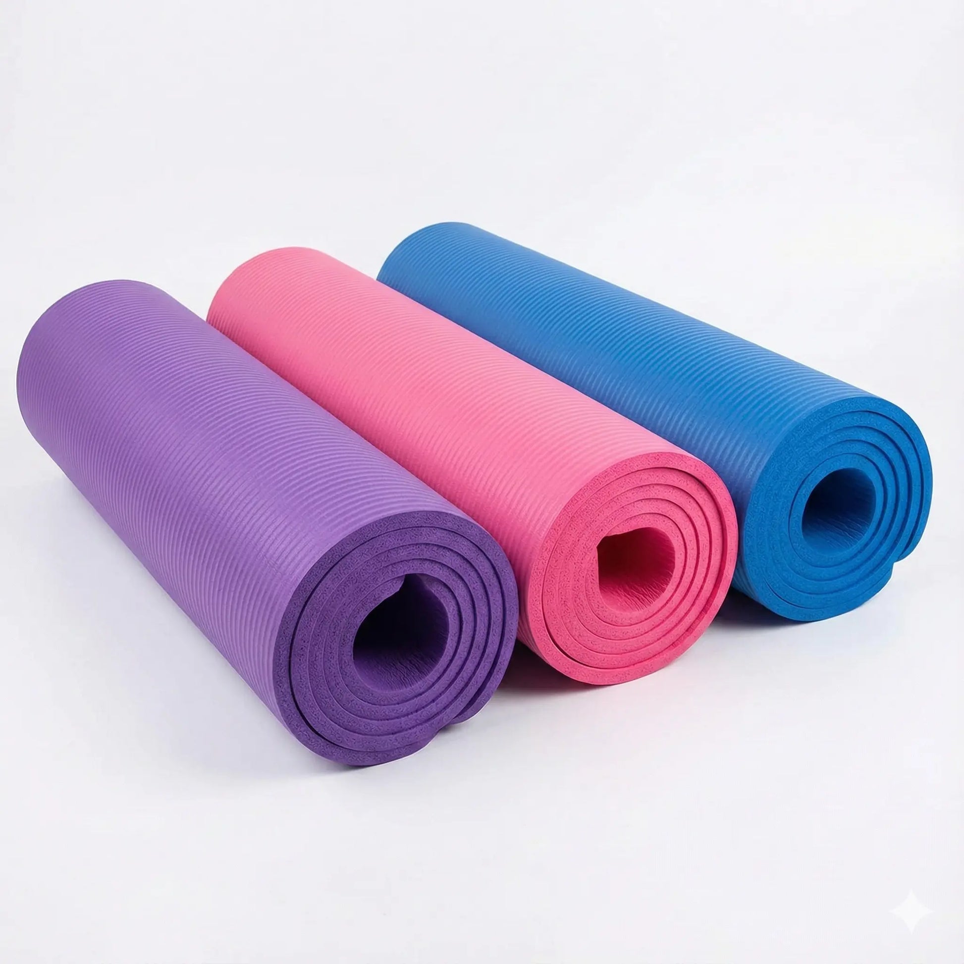 Exercise mats in purple, pink and blue rolled up side by side showing available colour options.