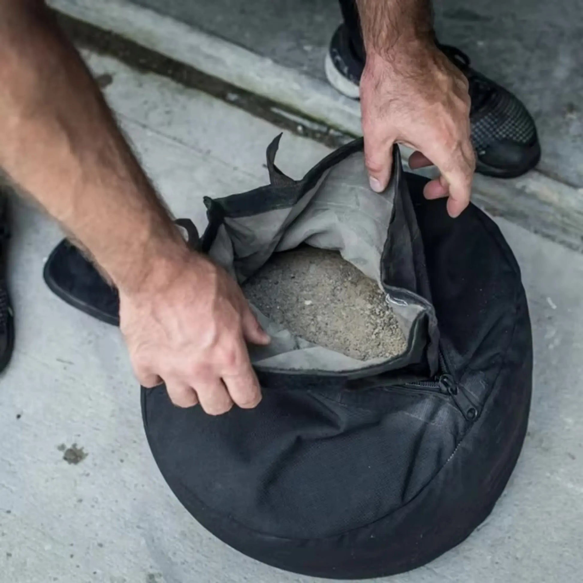 Exercise sandbag inner filler bag being filled with sand