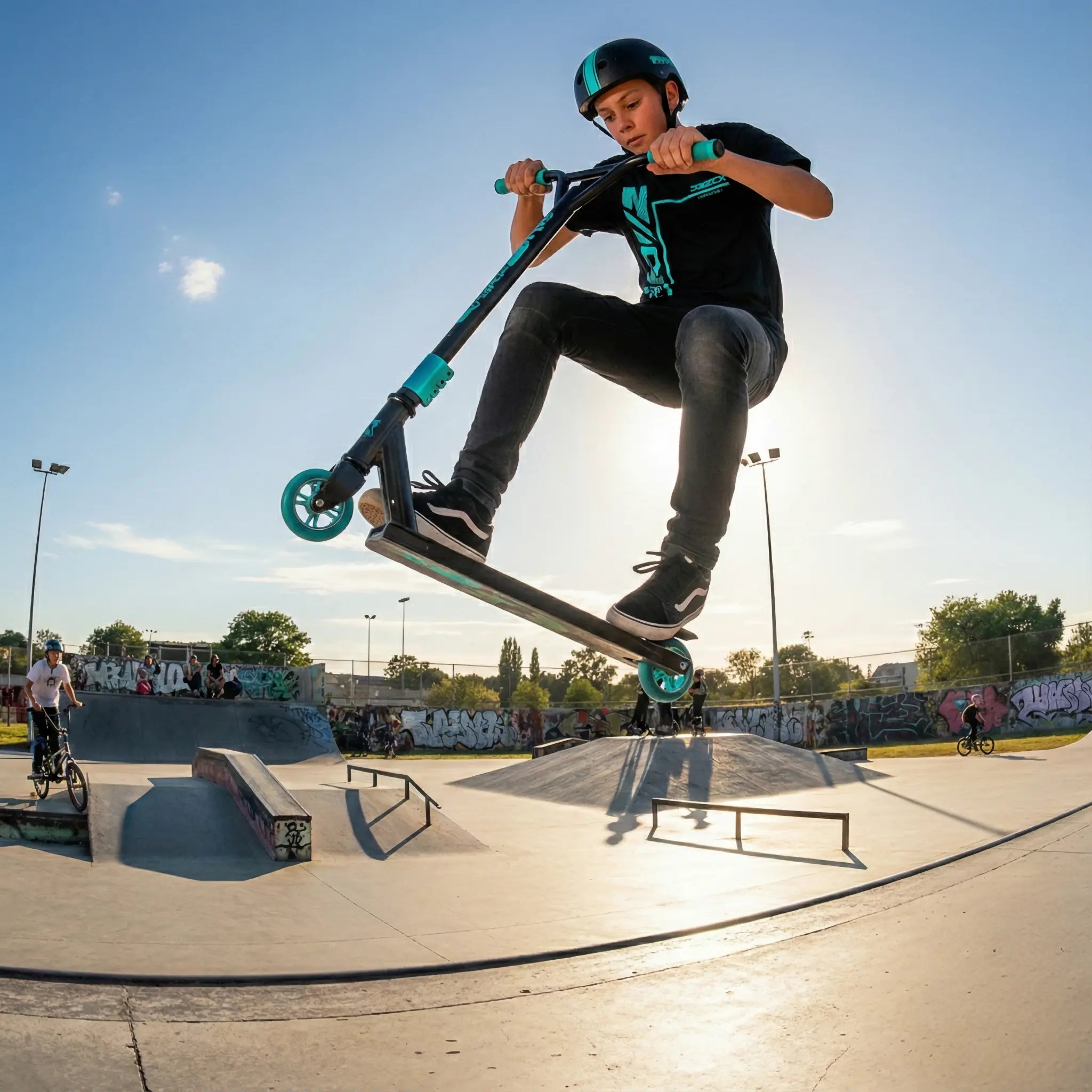 Teen performing a stunt trick on a Fun & Sport scooter at the skatepark.