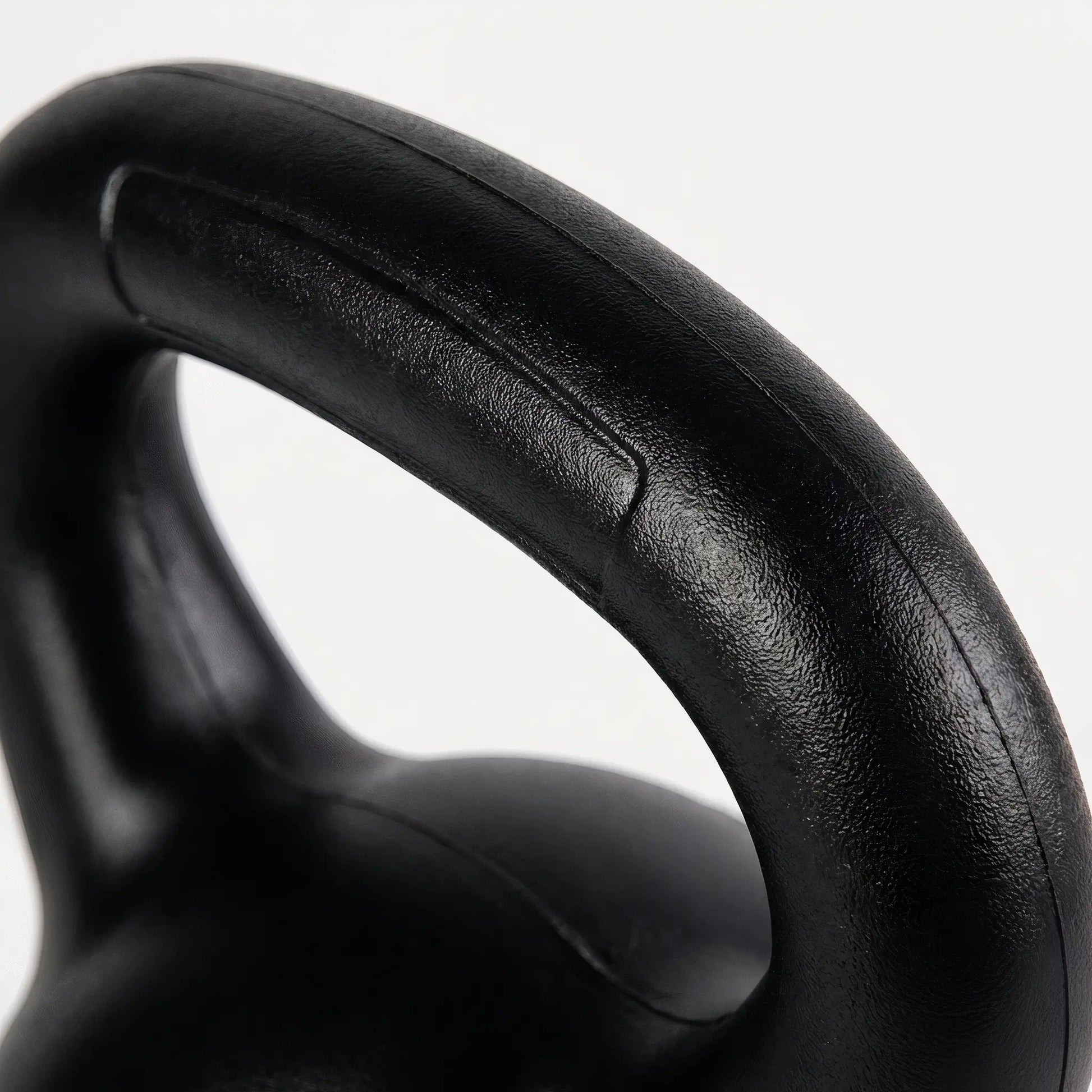 Close-up of textured kettlebell handle for secure grip during workouts
