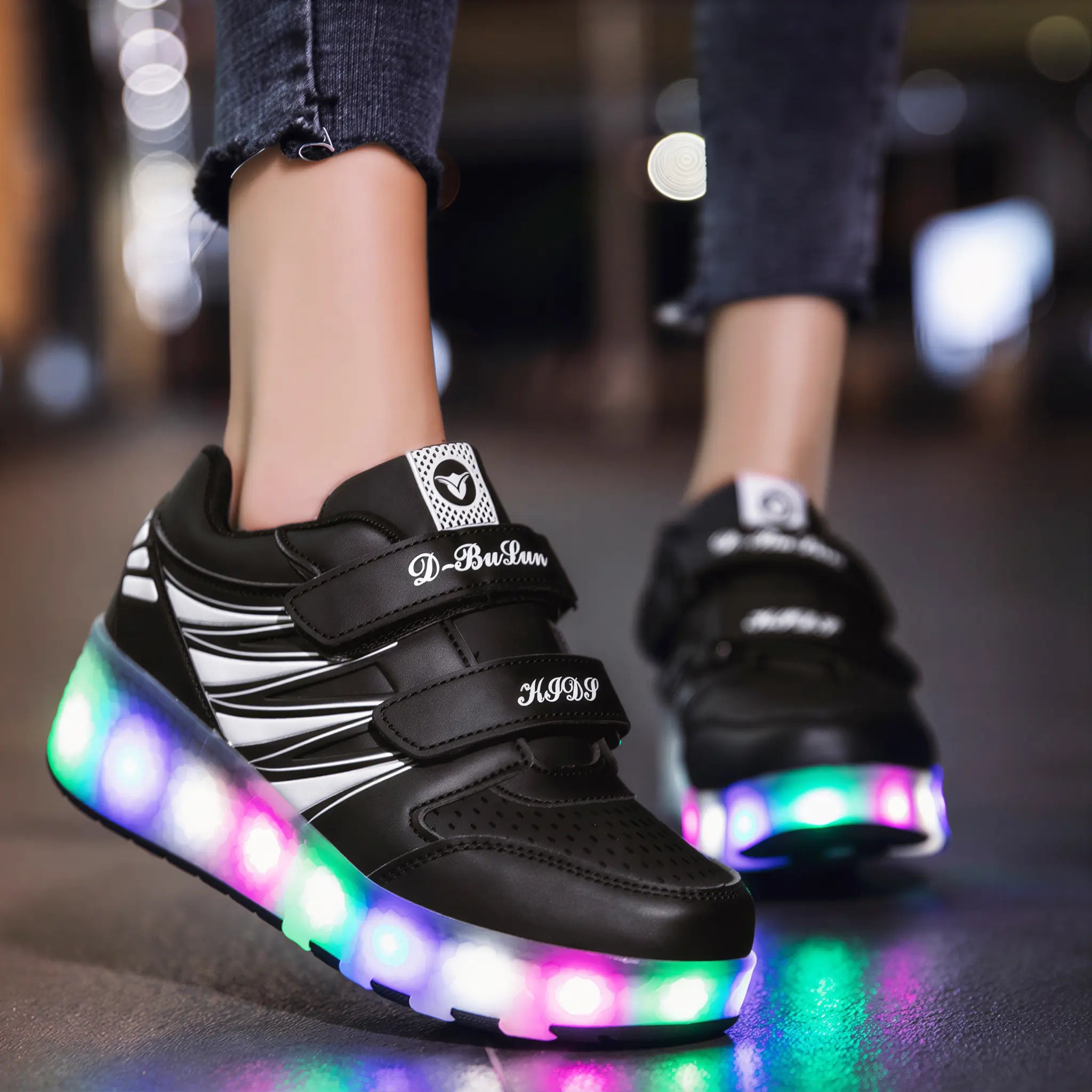 Child wearing black LED rolling skate shoes with wheels retracted in walking mode