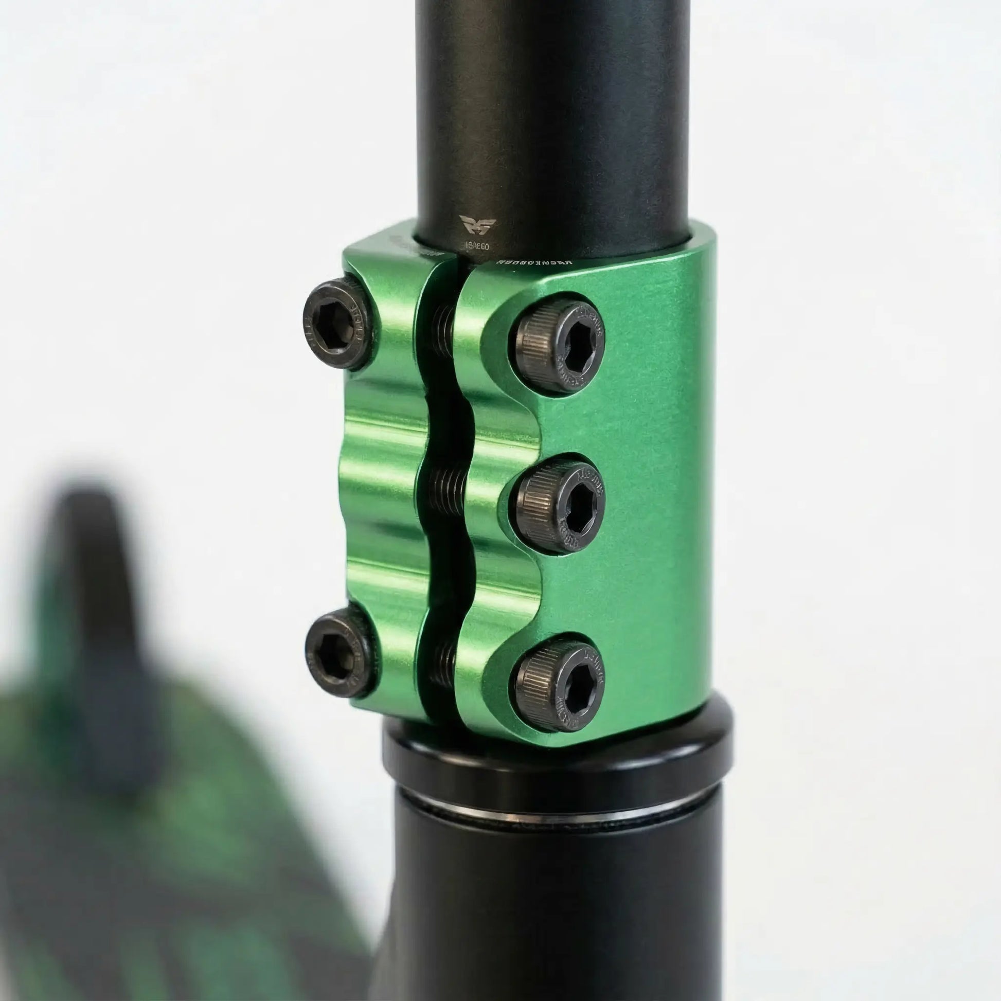 Close-up of quad-bolt clamp securing stunt scooter handlebars for added strength and stability