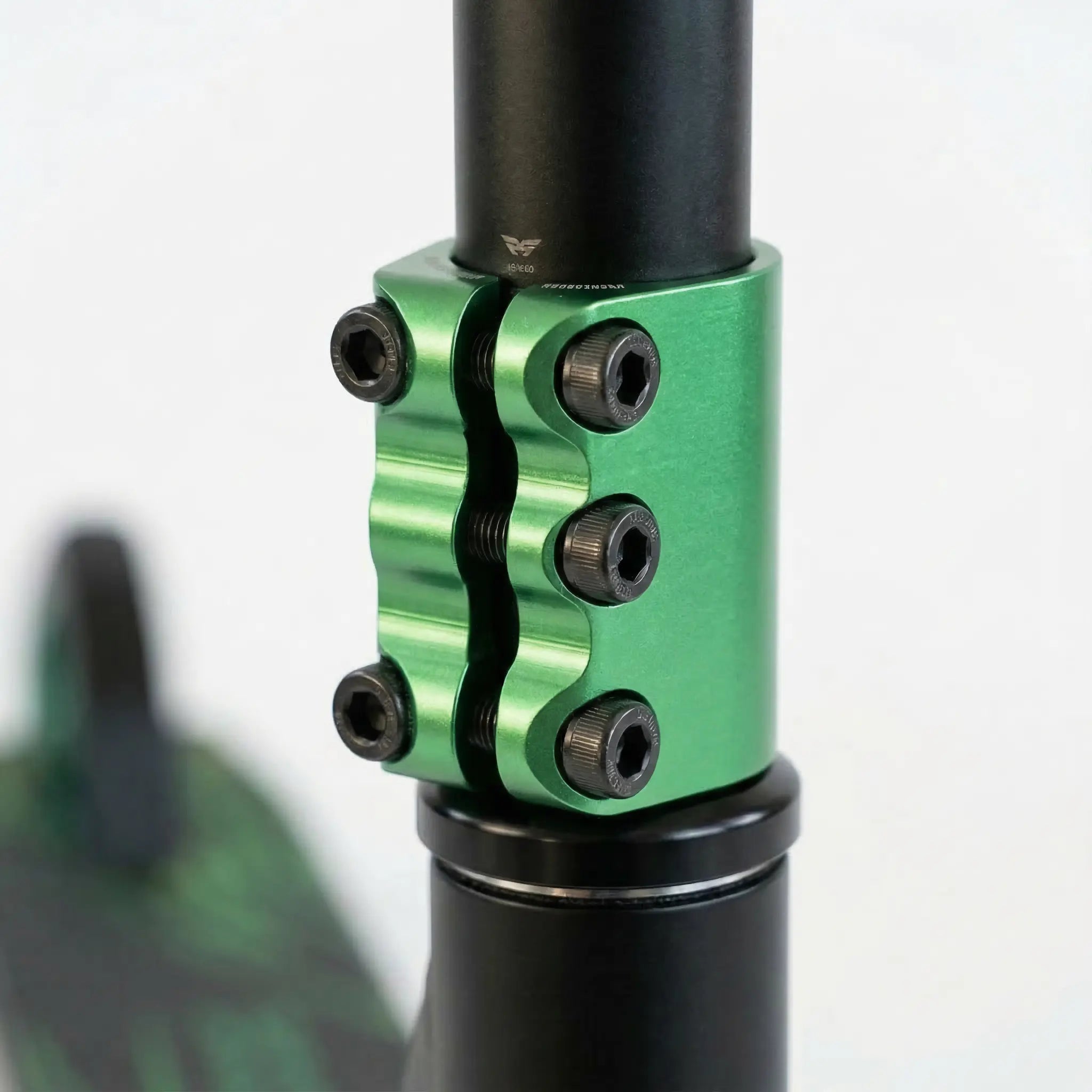 Close-up of quad-bolt clamp securing stunt scooter handlebars for added strength and stability