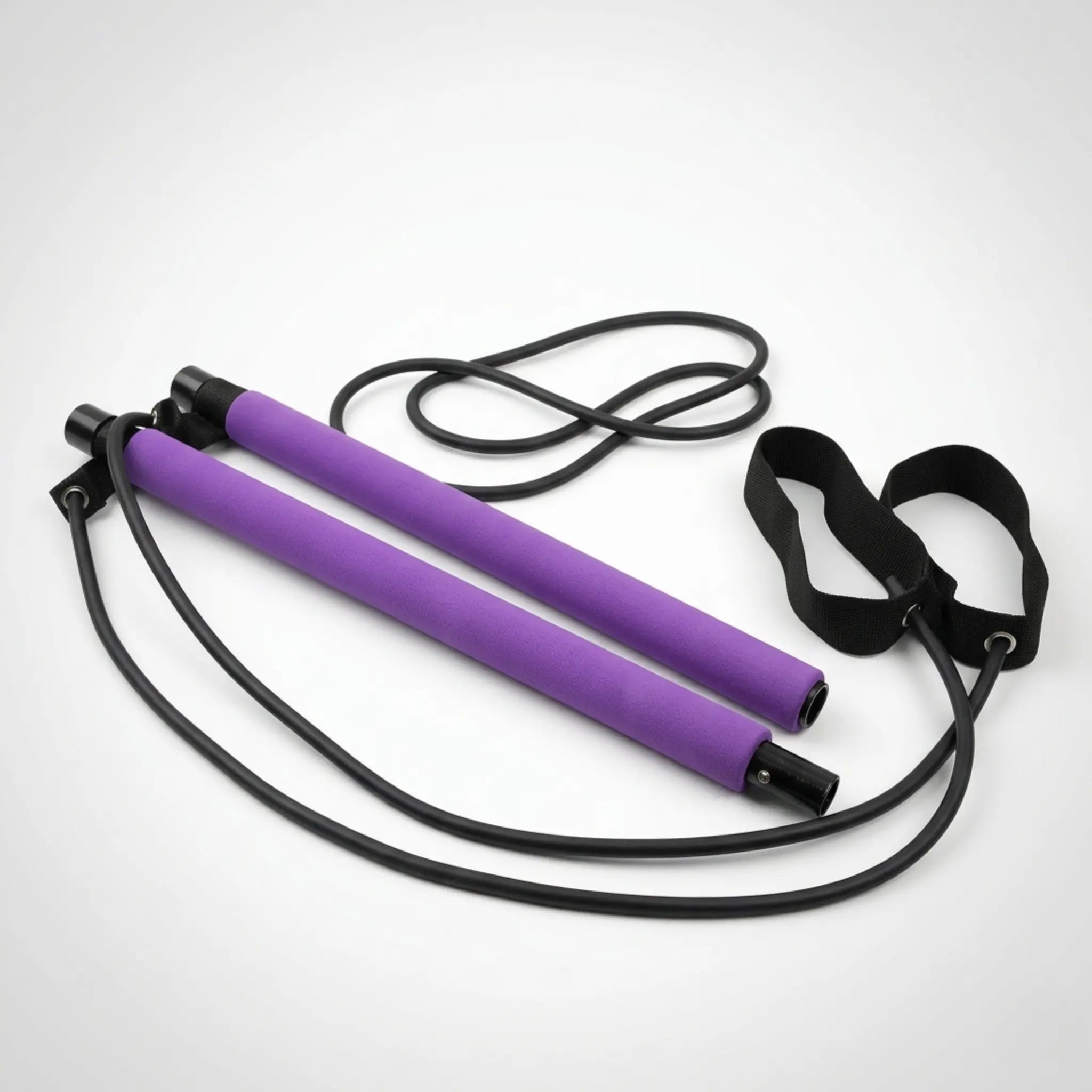 Pilates bar kit with resistance bands, ankle straps, and carry bag arranged on a neutral studio background