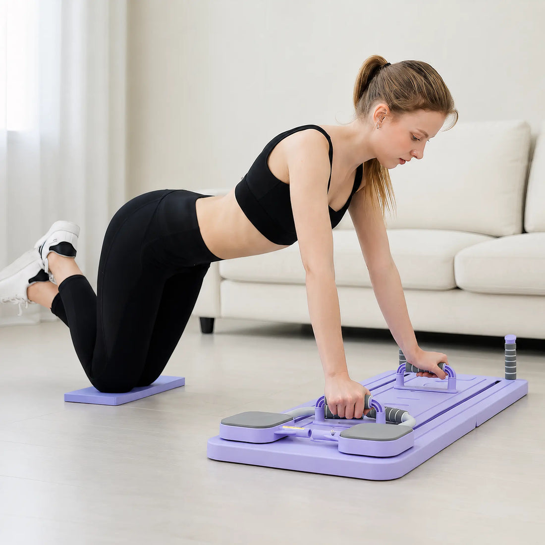 Foldable Pilates board with resistance bands and spring-assisted sliding rails on white background