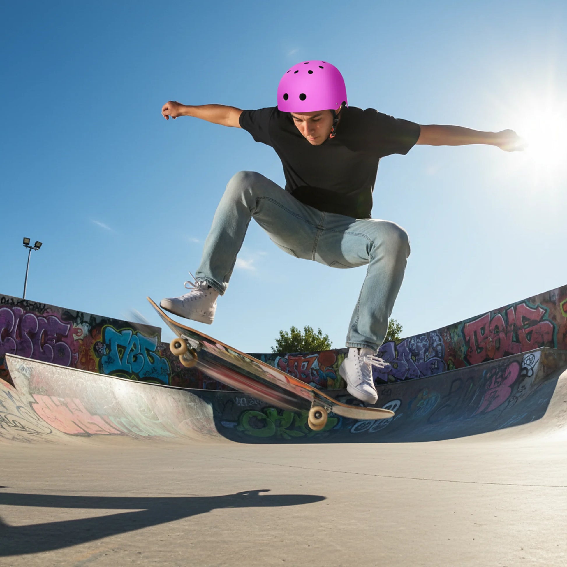 Rider wearing helmet performing trick at skatepark demonstrating impact protection use