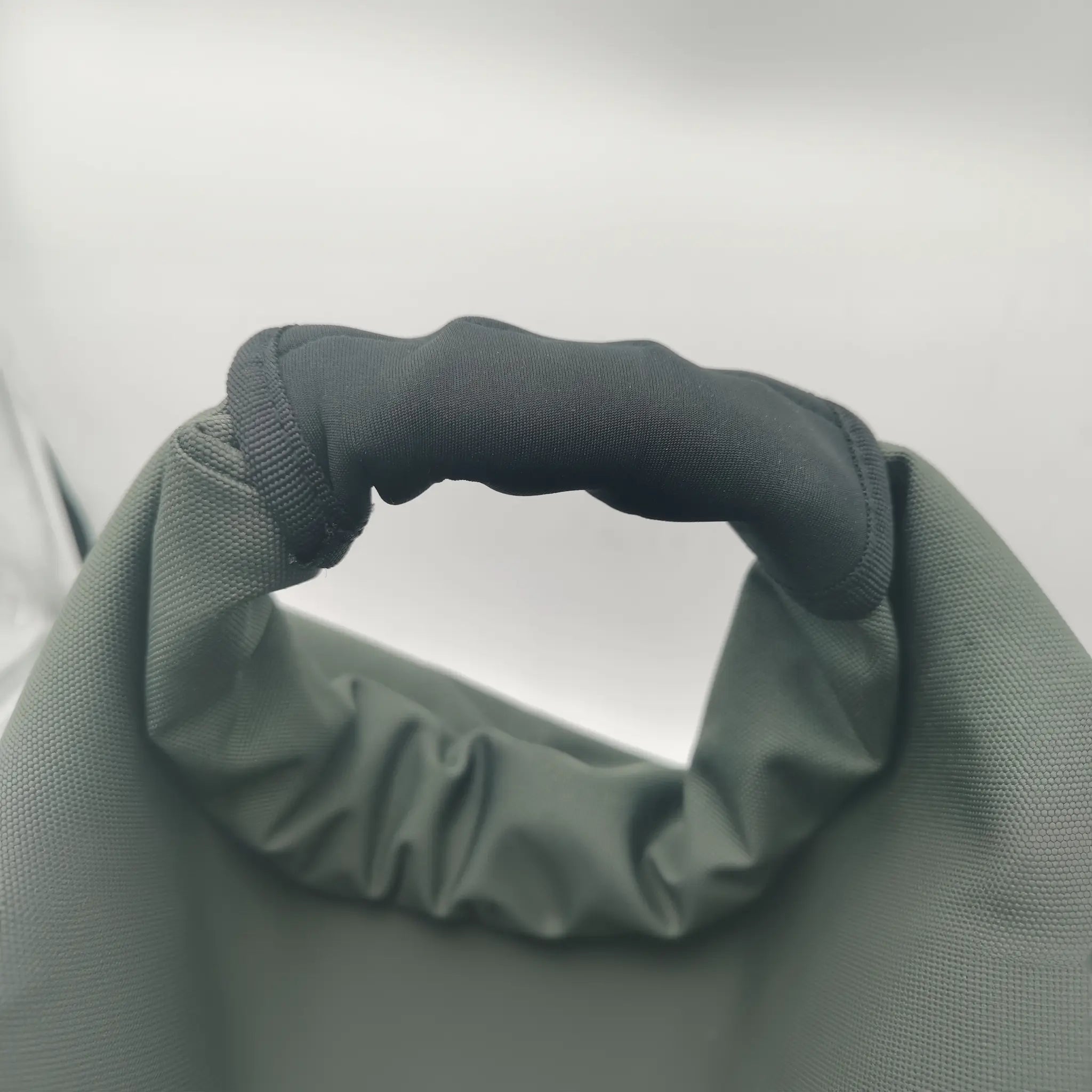 Close-up of padded handle on soft kettlebell for comfortable grip during swings