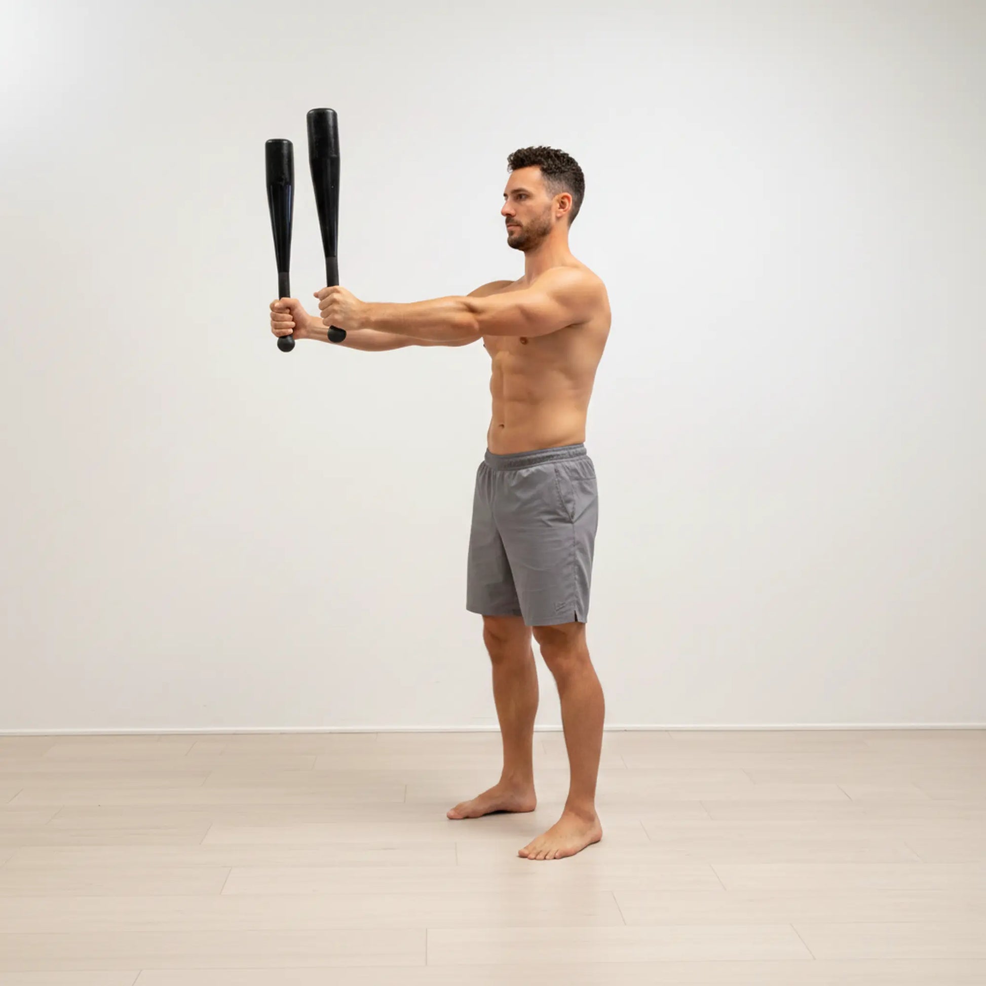 Steel club front hold exercise for shoulder stability and control