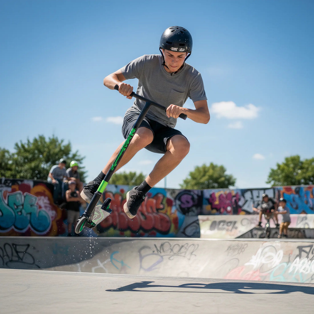 Teen performing a jump trick on a stunt scooter at a skatepark