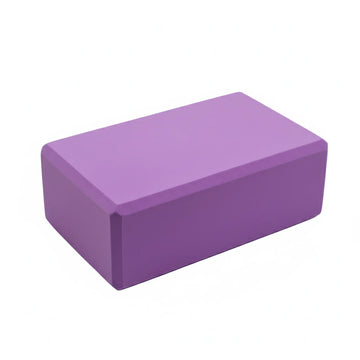 Angled studio shot of a purple EVA foam yoga block.